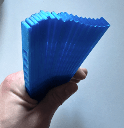 Blue flexible clamp test piece for checking BajkBuddy fit and spacing